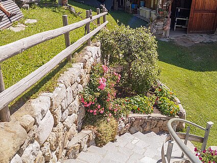 Stairs to the terrace with flower bed
